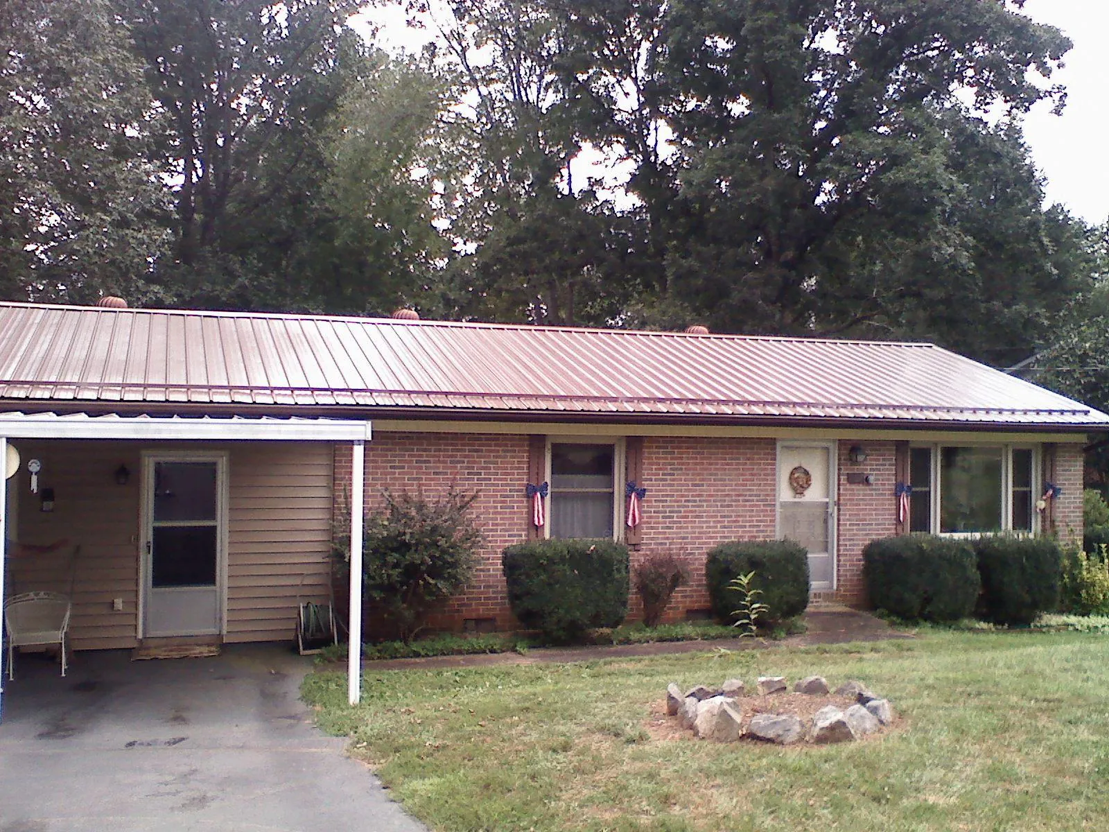 Bronze metal roof and carport on a brick ranch home — Roof Repair work by our crew in North Scituate